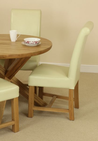The Solid Oak Round Table With Crossed Legs And Four Cream Scroll Back