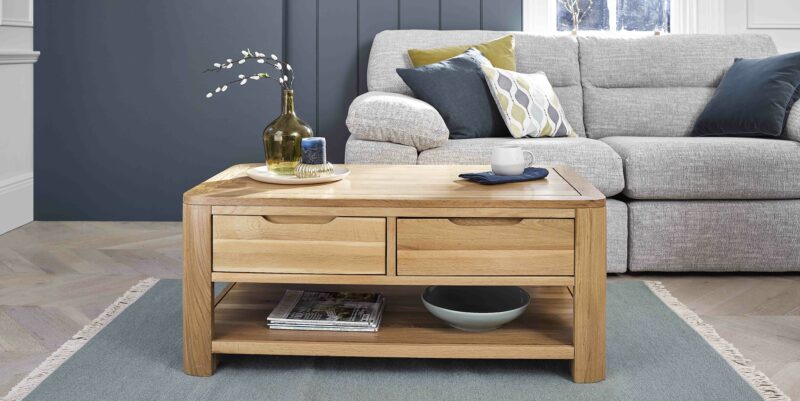 Oak Furnitureland Romsey natural oak coffee table in a living room with a grey sofa.