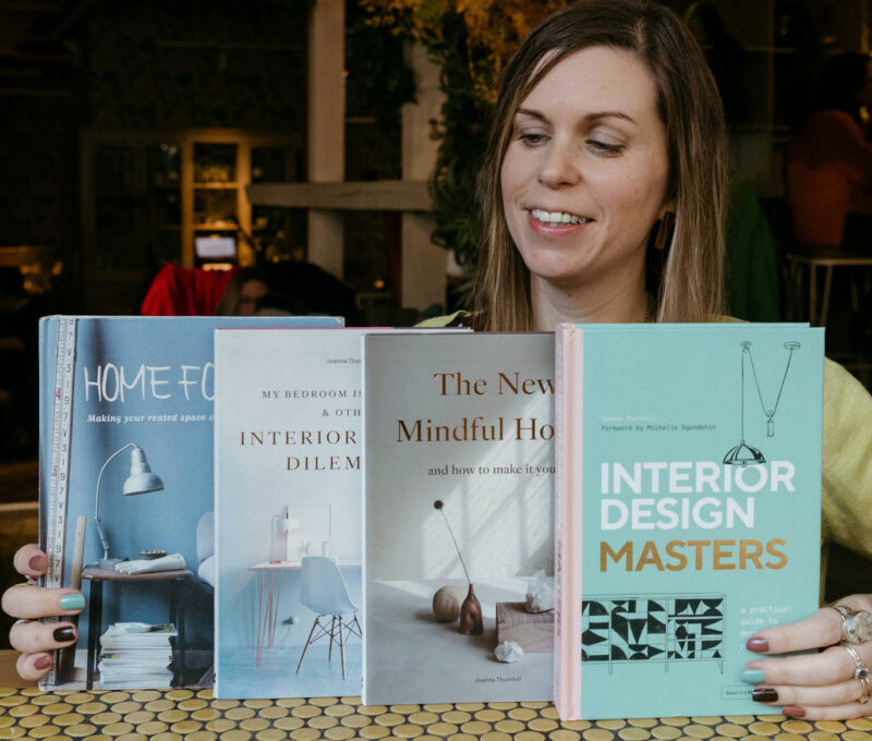 Interior stylist Joanna Thornhill pictured holding up her interiors books. 