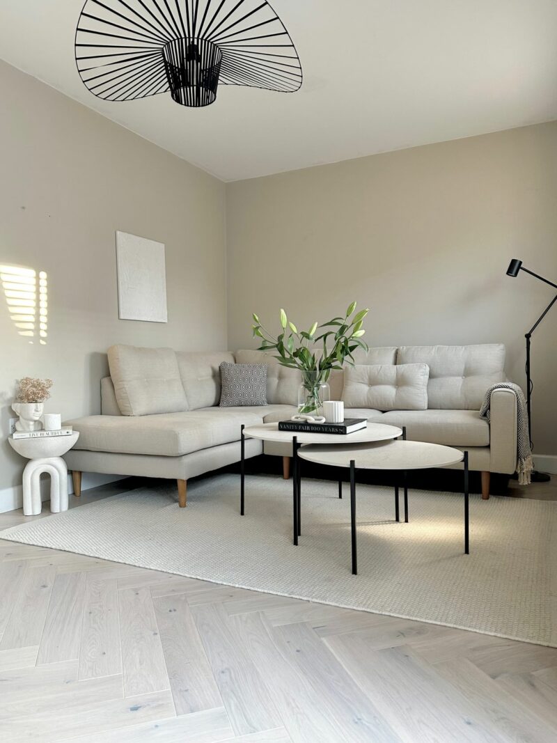 Oak Furnitureland Brighton corner sofa in cream upholstery styling in a monochrome living room.