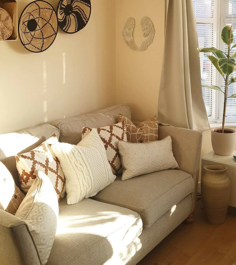 Oak Furnitureland cream Gainsborough sofa in a boho-inspired living room with lots of cushion and rustic accessories.