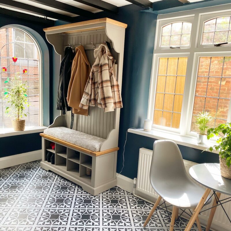 Patterned tiled hallway with dark blue walls featuring the St. Ives grey painted hallway unit with shoe storage and coat hooks.