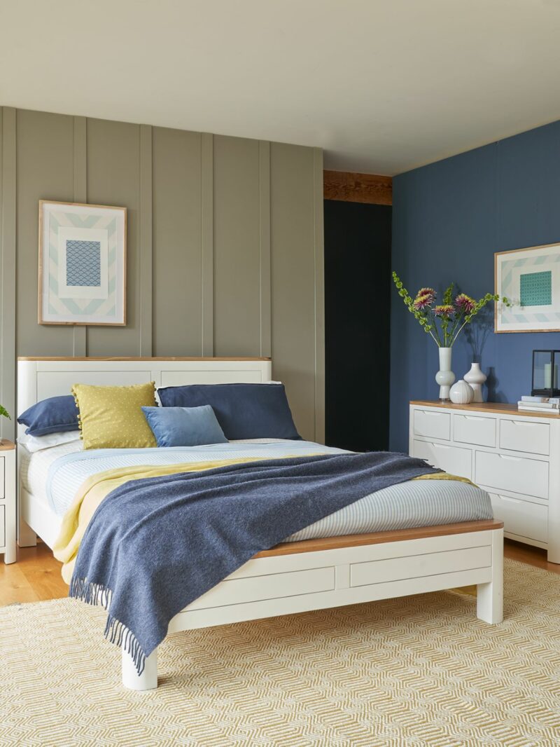 Oak Furnitureland painted white Hove bedroom furniture range, with blue walls and coordinating bedding.