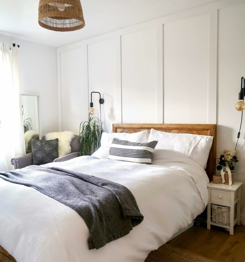 White bedroom with plants and Oak Furnitureland Parquet oak double bed.