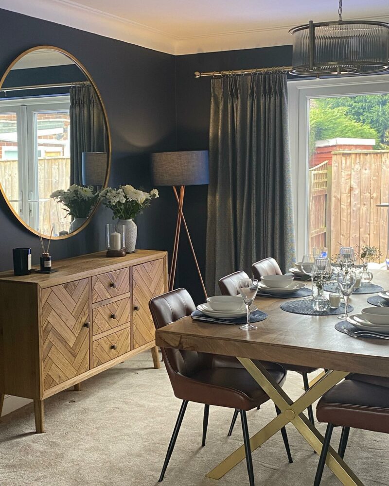 Dark grey dining room with Parquet sideboard and metallic accents.