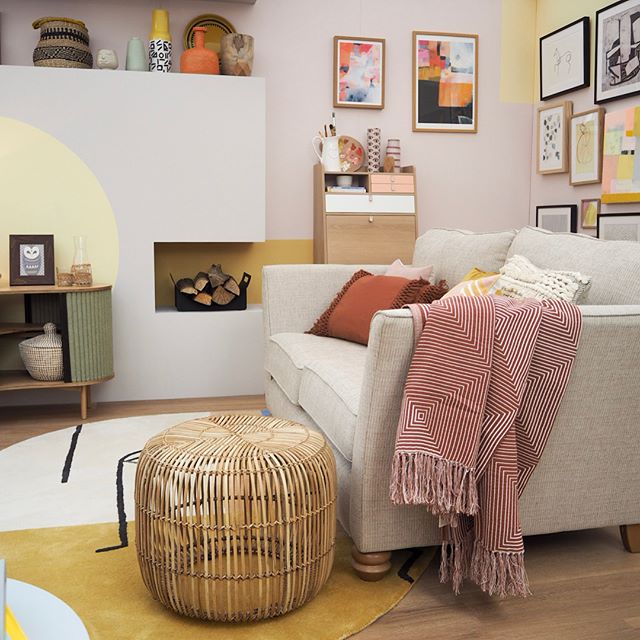 Oak Furnitureland neutral sofa in a colourful living room with a gallery wall and cosy cushions and blankets.