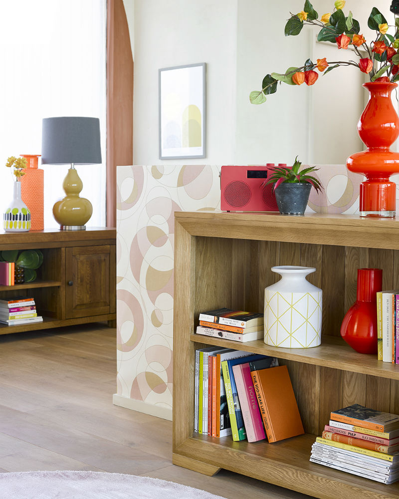 A natural oak bookcase in a 70s-inspired living room