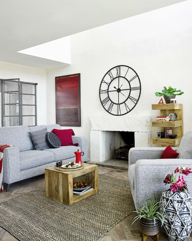 A neutral, monochrome living space with pops of ruby red for a globally-inspired feel