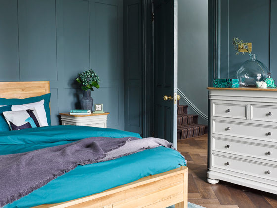 blue green toned bedroom with oak double bed