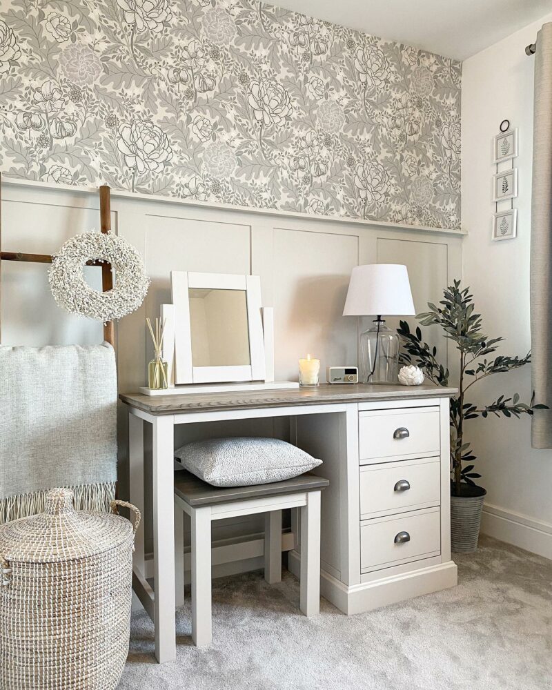 Neutral and peaceful bedroom scheme with a white painted dressing table and matching stool.