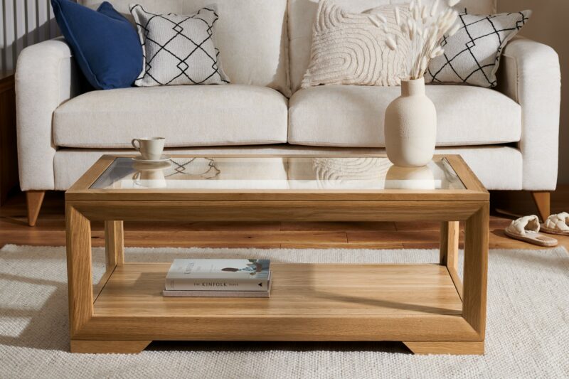 Close up of Oak Furnitureland Hepburn cream sofa with the Bevel oak and glass-topped coffee table.
