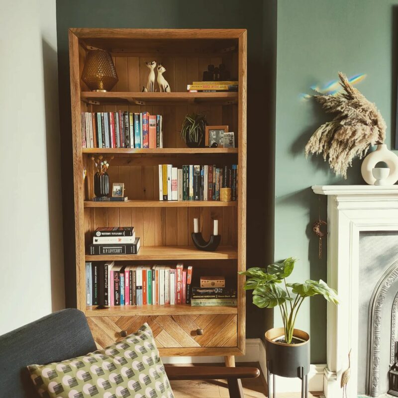 Green living room featuring an Oak Furnitureland Parquet bookcase filled with books, decorative accessories.