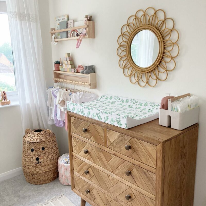 Neutral nursery featuring Oak Furnitureland Parquet chest used as a changing table for a baby.