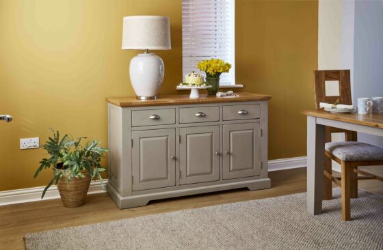 Grey sideboard against yellow living room wall