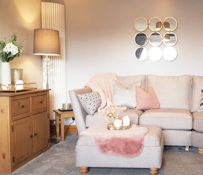 Beige Gainsborough sofa with floor lamp and pink accessories.