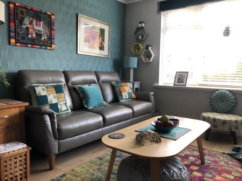 Grey leather sofa in blue living room