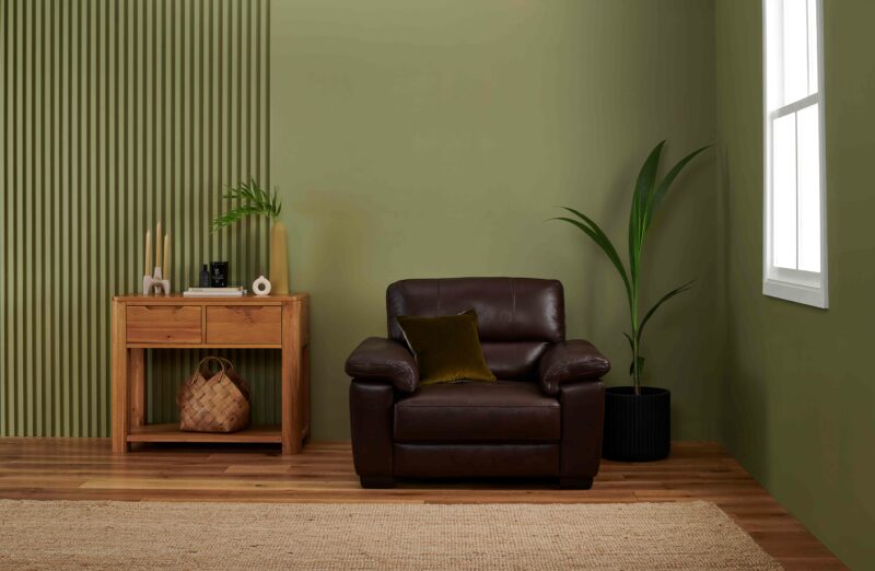 Oak Furnitureland brown leather Turin armchair in a green room.