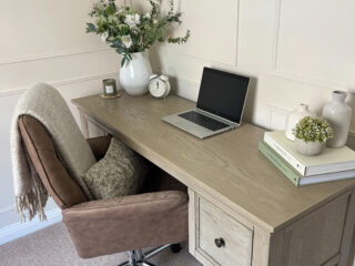Oak Furnitureland Burleigh weathered oak desk in a neutural home office with a laptop, books and plants.