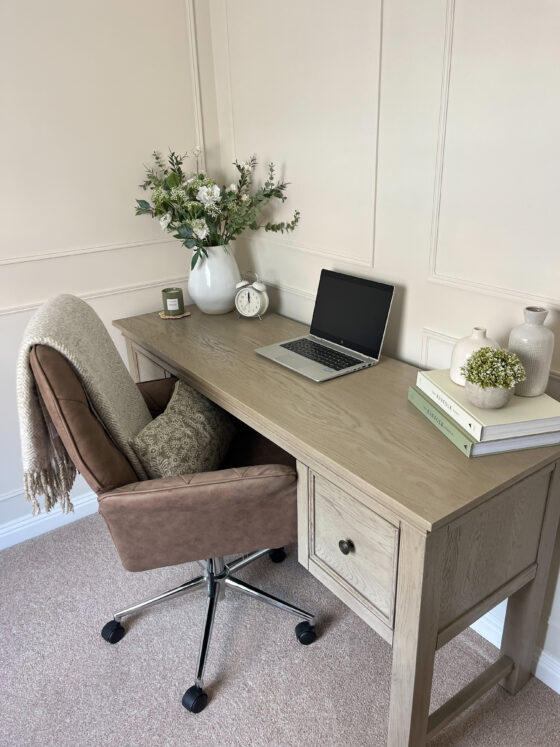 Oak Furnitureland Burleigh weathered oak desk in a neutural home office with a laptop, books and plants.