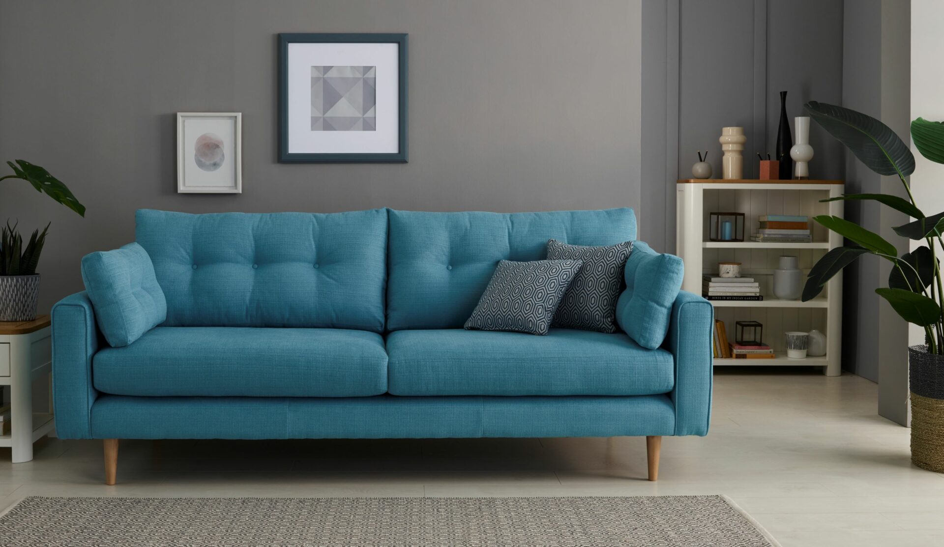 Brighton teal mid-century style sofa with slim wooden legs in a stylish living room.