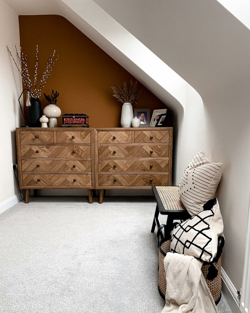 Two Parquet chest of drawers next to each other in an attic room with a mustard feature wall.