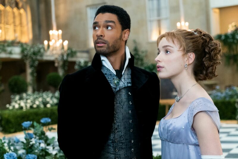 Still from Netflix's Bridgerton featuring the Duke and Daphne standing together at a ball. 