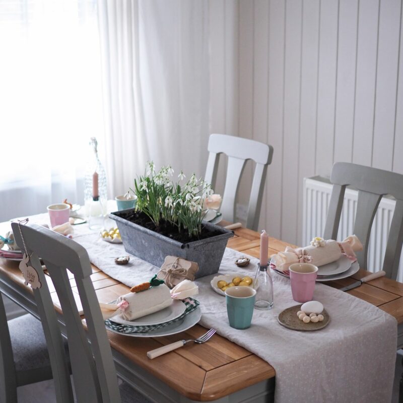 Oak Furnitureland painted grey and oak dining table set with Easter decor and snowdrop centrepiece.