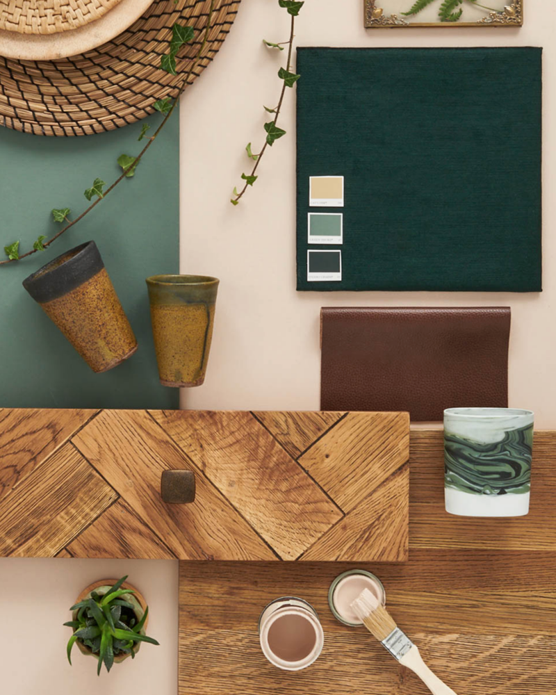 Flatlay decor inspiration featuring Parquet furniture, rich green accents, leather upholstery and plants.