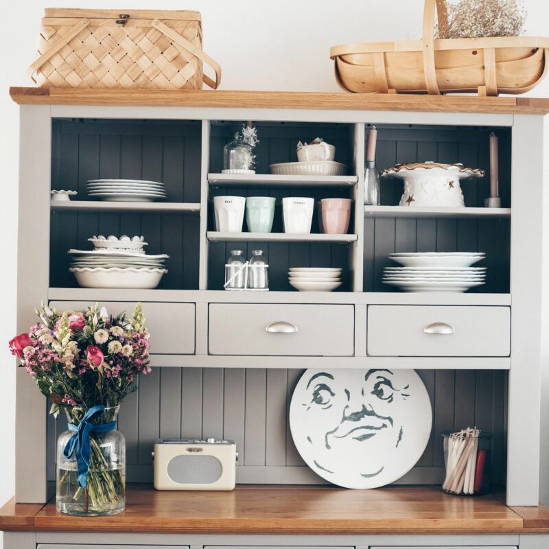 Oak Furnitureland St. Ives grey painted dresser with a bouquet of flowers & styled with crockery.