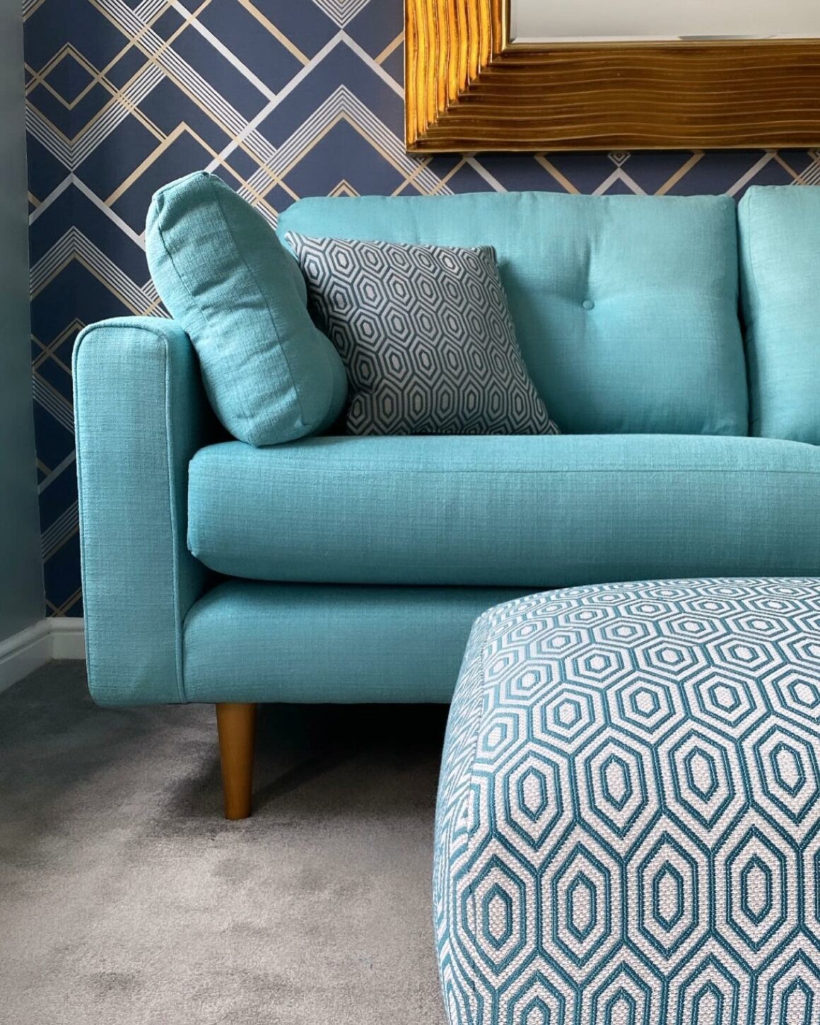 Oak Furnitureland aqua blue Brighton retro-style sofa with geometric patterned footstool and matching scatter cushion.