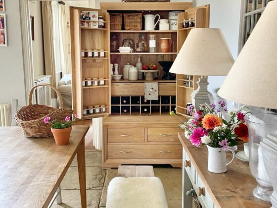 Bevel natural oak larder in a rustic kitchen, organised with stylish storage.