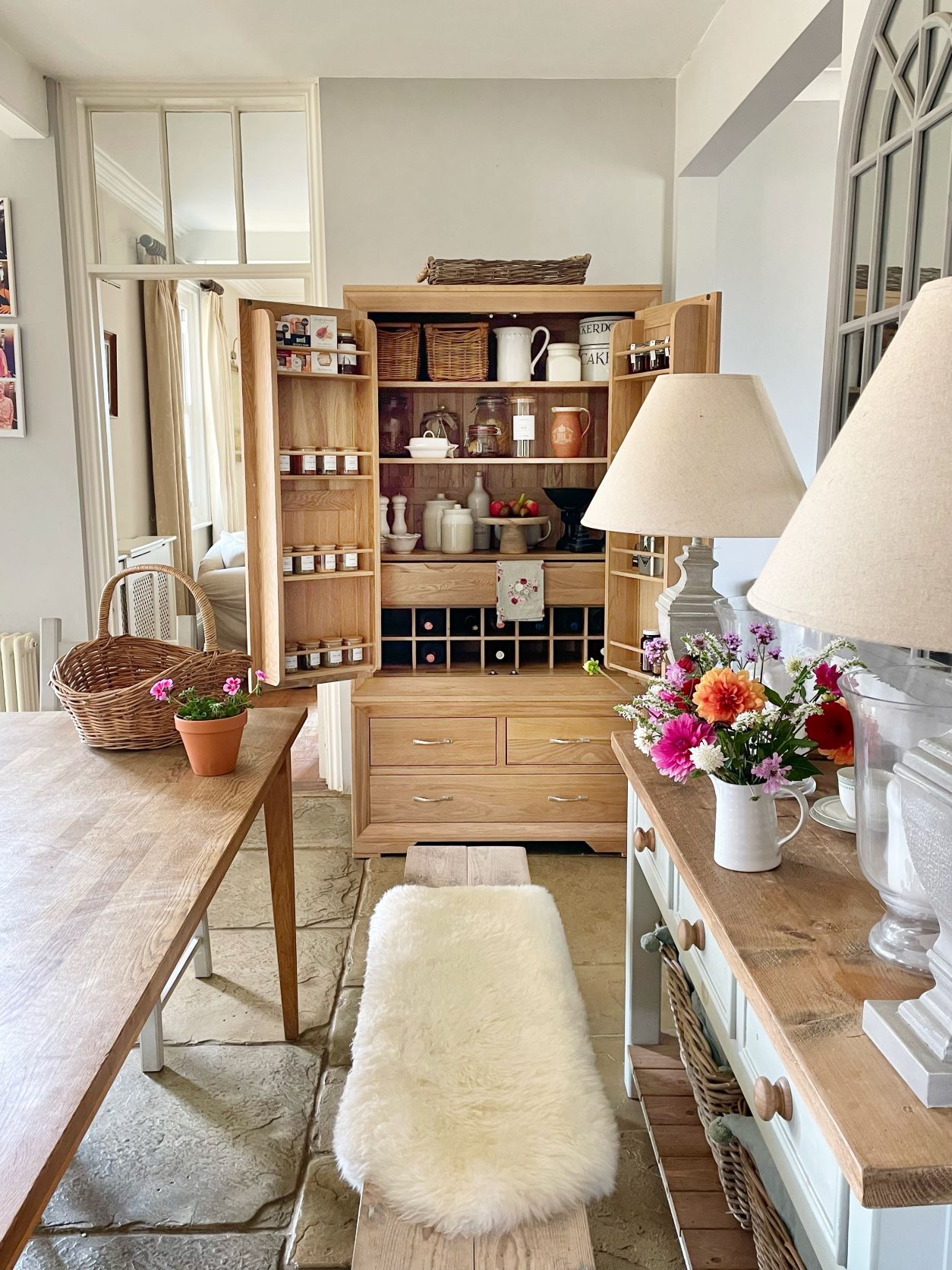 Bevel natural oak larder in a rustic kitchen, organised with stylish storage.