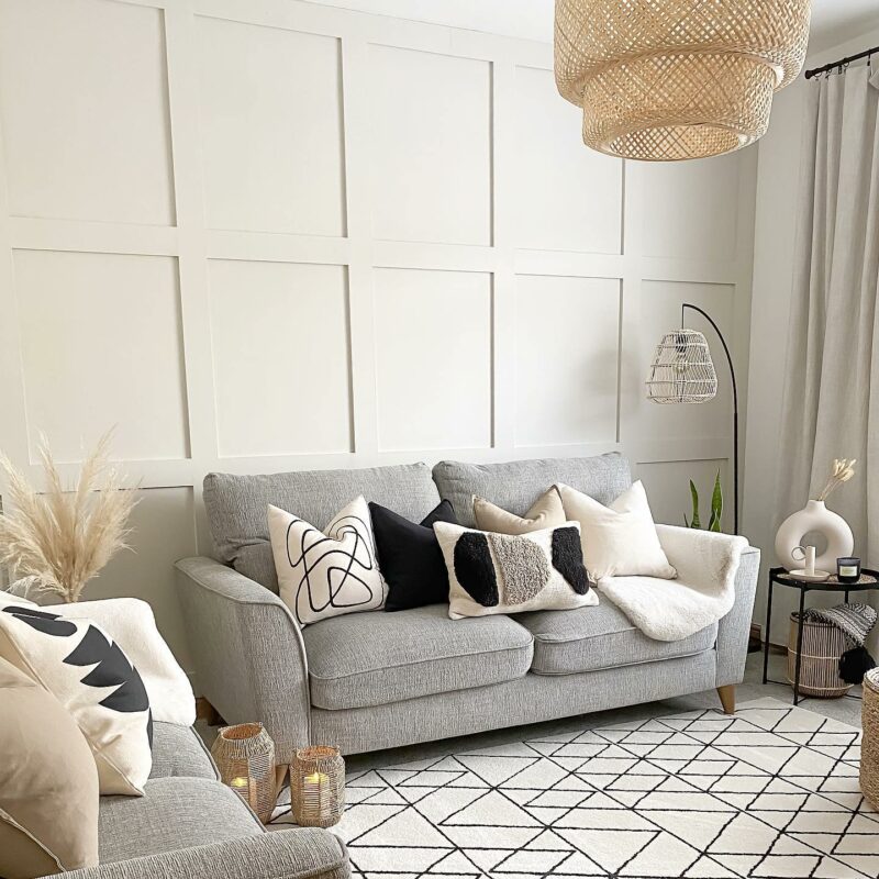 Modern neutral living room featuring the Jensen retro-style sofa in grey fabric with tactile neutral and monochrome cushions.