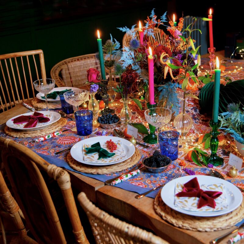 Colourful maximalist festive decor tablescape set for Christmas celebrations.