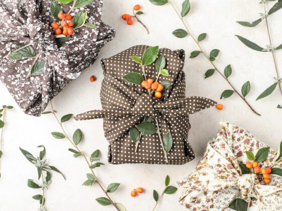 Sustainble fabric Christmas wrapping flatlay of three presents.