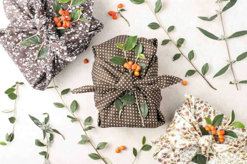 Sustainble fabric Christmas wrapping flatlay of three presents.