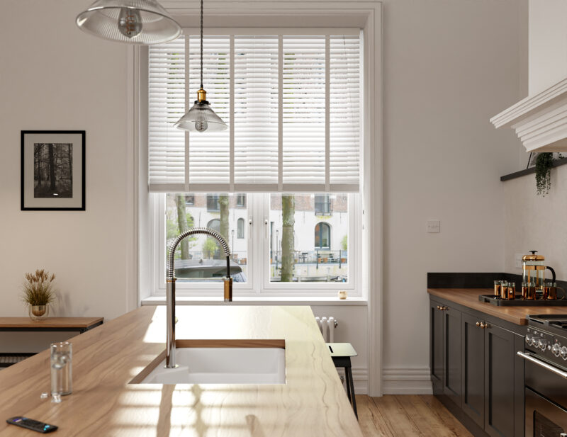 Light-filled kitchen with white walls, wooden blinds and neutral decor.