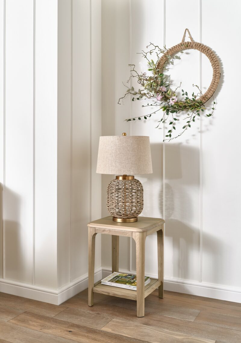 Oak Furnitureland Newton side table and lamp with wall mounted foliage wreath