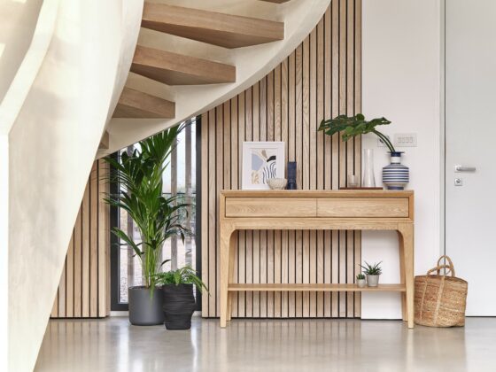 Oak Furnitureland Aston range console table in a dramatic modern hallway with a sweeping staircase.