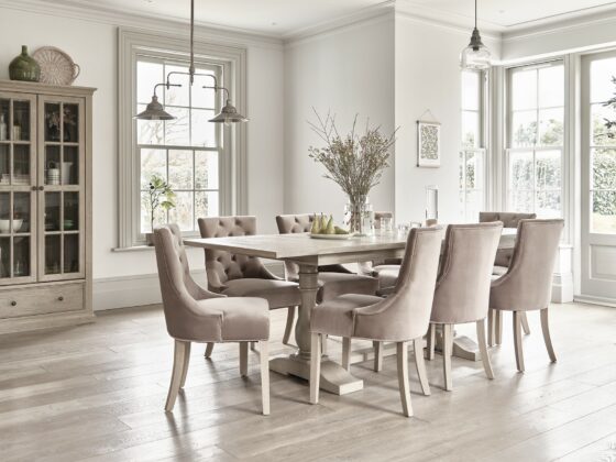 Oak Furnitureland Burleigh extendable dining table in a light-filled room with a matching glazed cabinet.