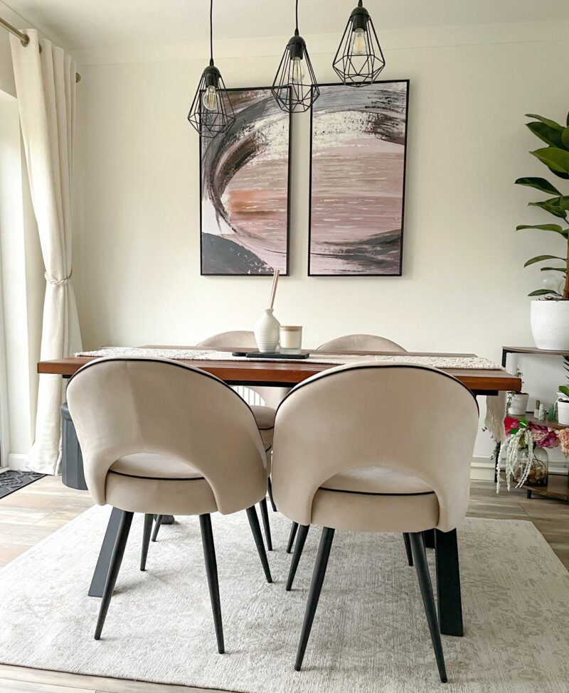 Neutral dining room with Oak Furnitureland Farne wall art in pink, blue and grey colour palette.