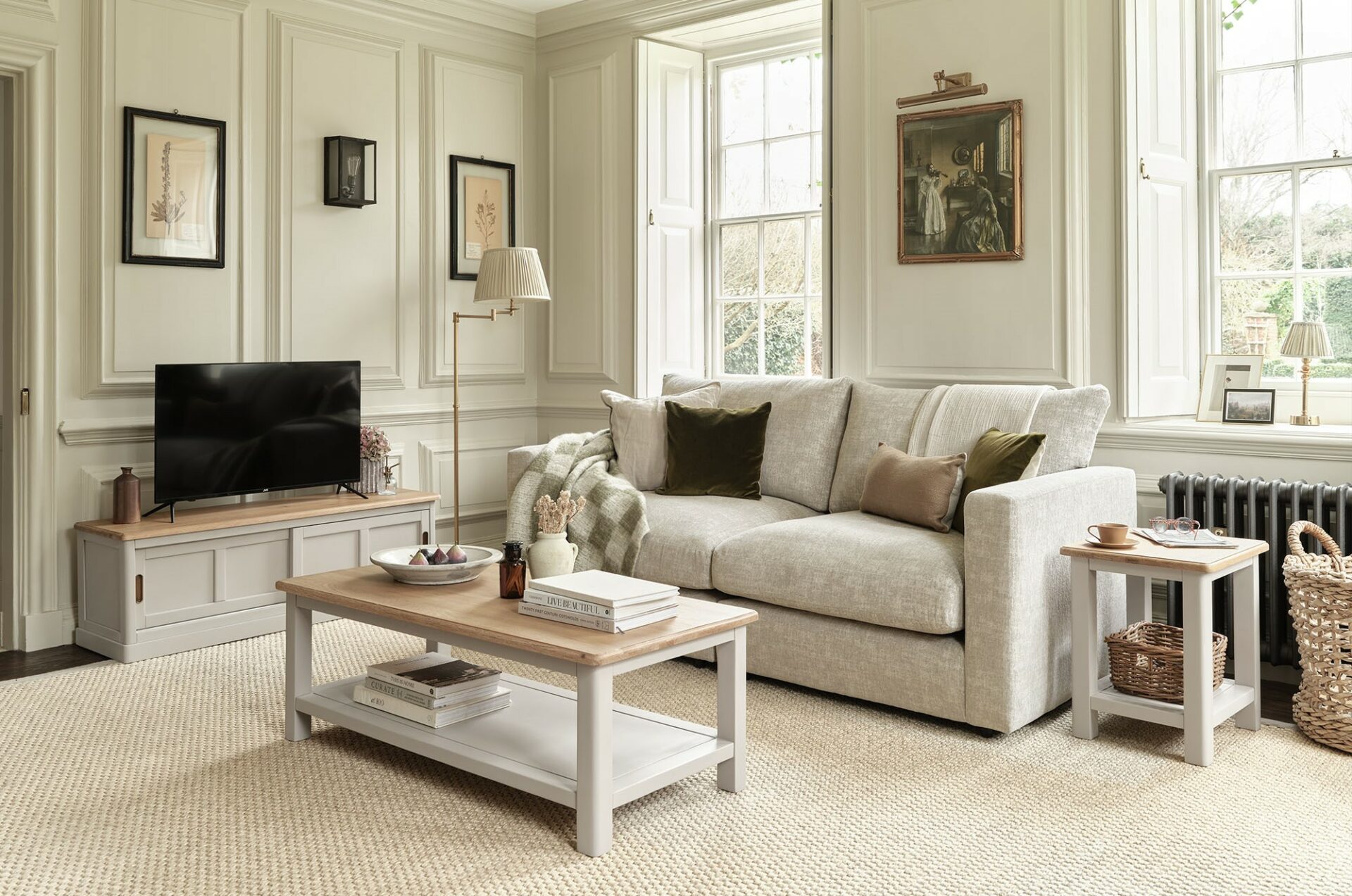 A sofa, coffee table and TV unit-living room furniture-painted wooden coffee table-sliding door wooden TV unit-beige sofa-framed artwork-wall panelling