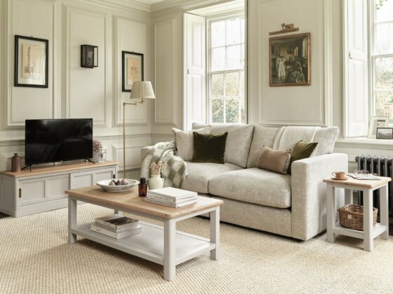 A sofa, coffee table and TV unit-living room furniture-painted wooden coffee table-sliding door wooden TV unit-beige sofa-framed artwork-wall panelling