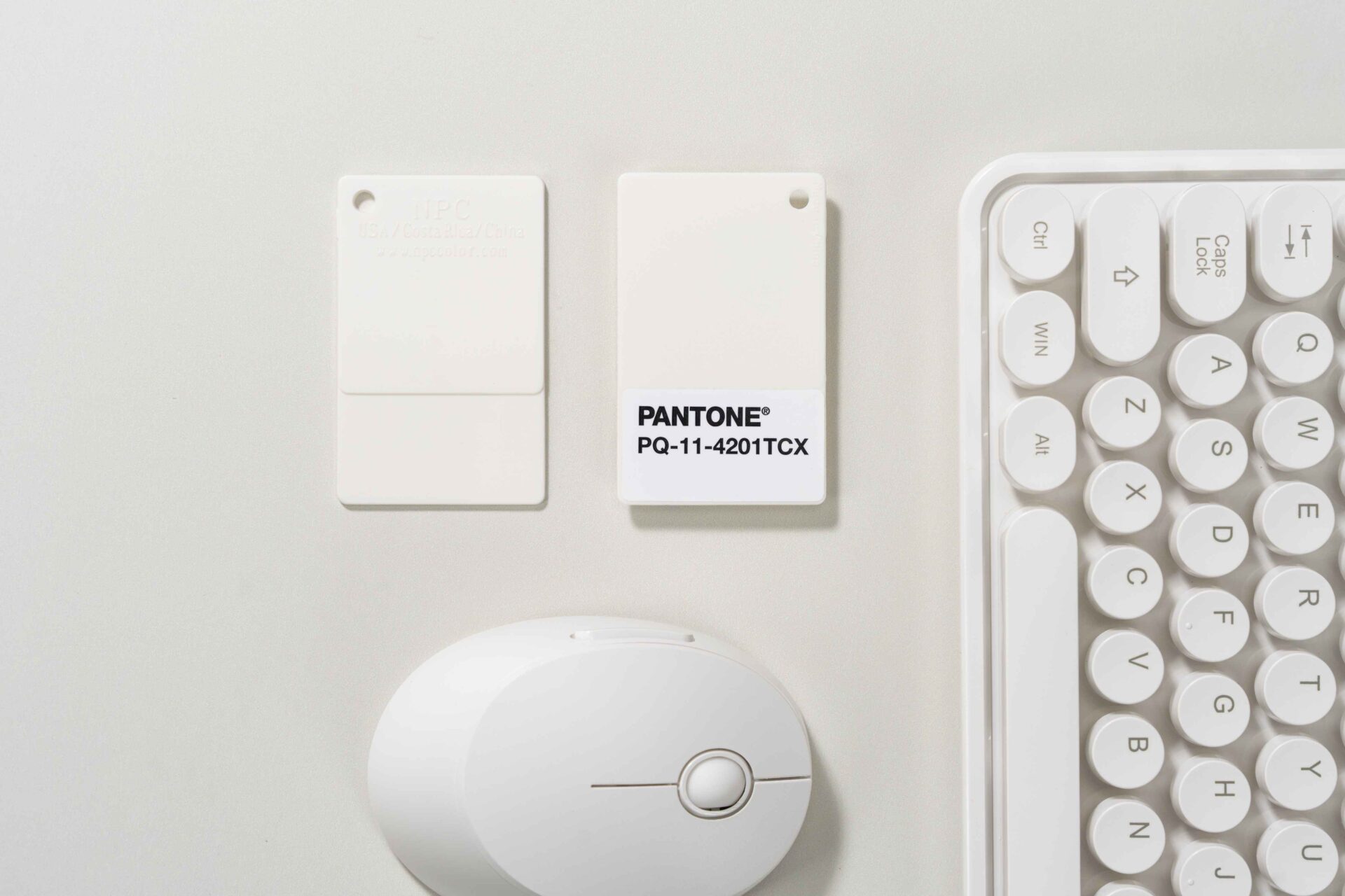 Pantone colour of the year 2026-cloud dancer-white keyboard-white mouse-white colour swatches-white tabletop