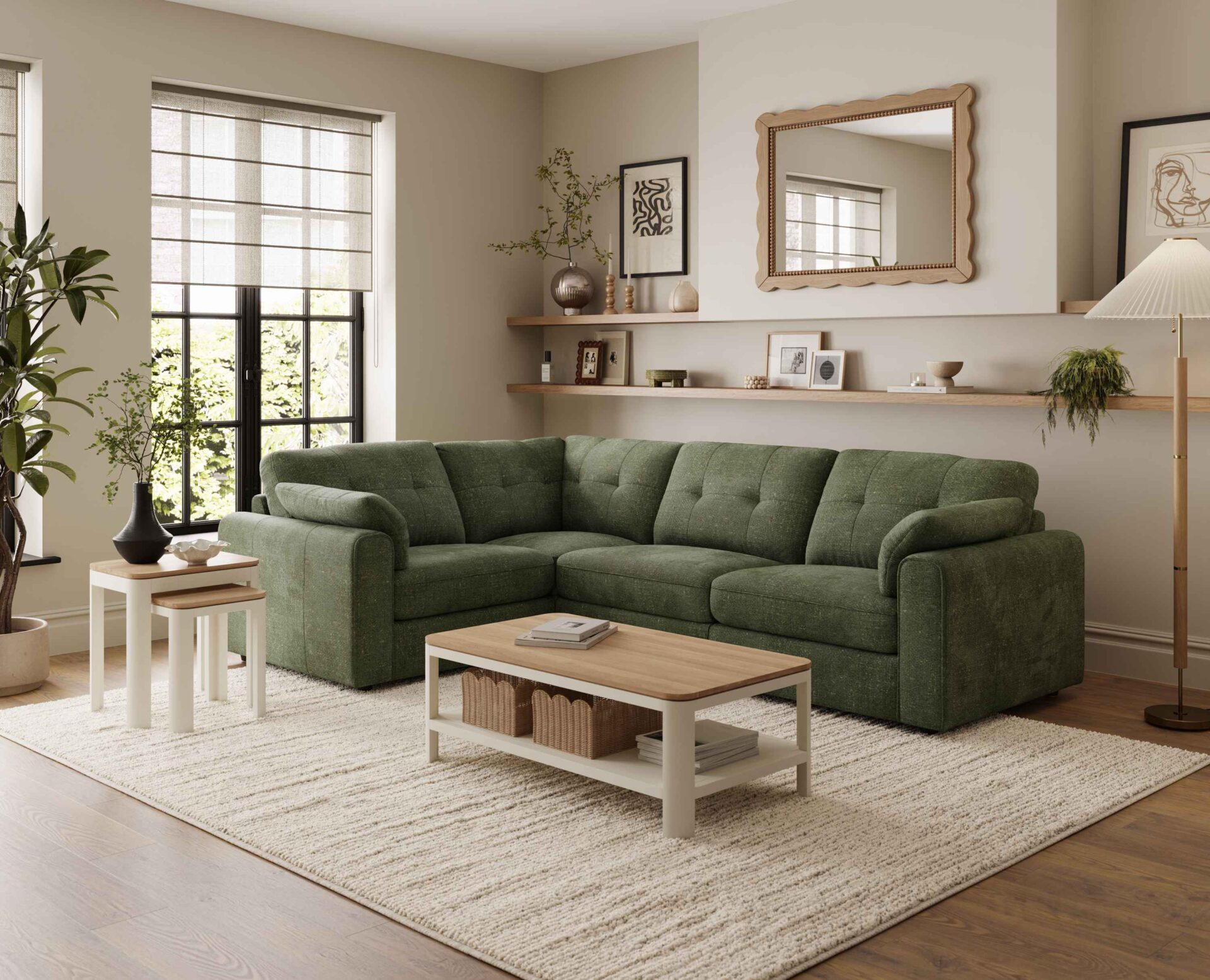 A corner sofa, coffee table, and nest of tables-living room furniture-dark green corner modular sofa-wooden and cream painted coffee table with shelf-wooden and cream painted nest of tables-cream textured rug-dark wooden floor-scallop edged mirror-built in wooden sheving-floor standing lamp-framed wall art-potted house plant-crittall windows-sheer blind