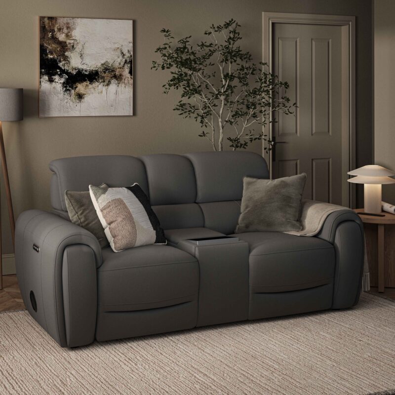 A leather sofa-living room furniture-grey leather 2 seater tech sofa-neutral textured rug-khaki green walls-potted house plant-wooden side table-cream table lamp-floor standing grey lamp-green cushions-block print textured cushion-abstract wall art-painted internal door